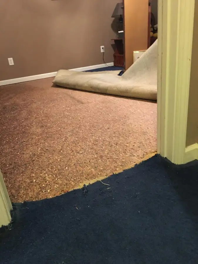 Carpet pad removal revealing water damage during Water Mitigation Services in Spencer